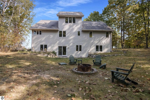 back of house with an outdoor fire pit