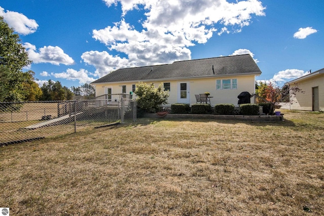 rear view of house featuring a yard