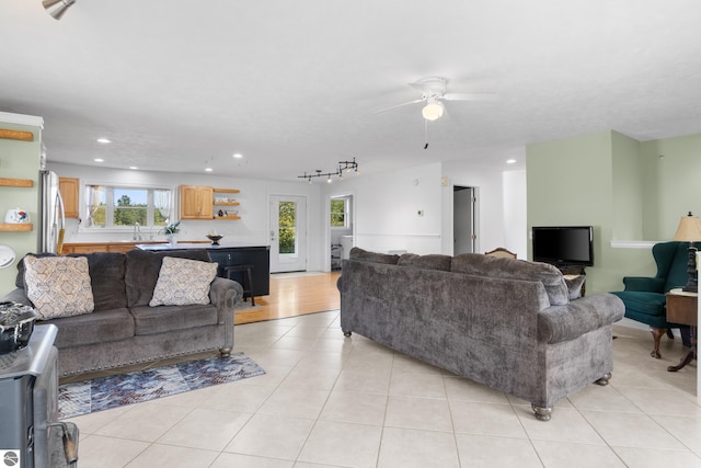 tiled living room featuring ceiling fan