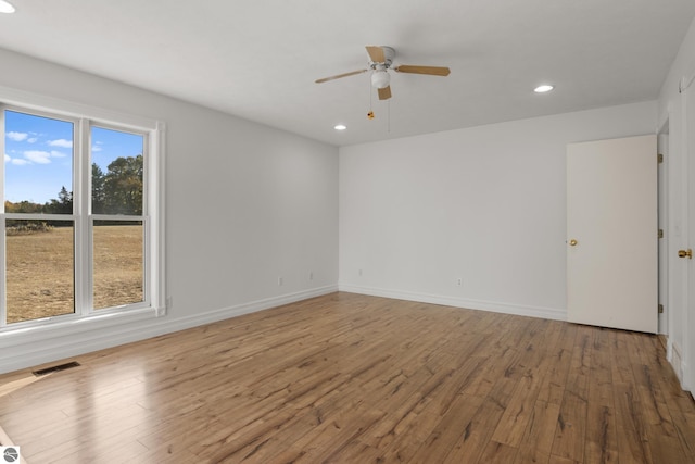 spare room featuring hardwood / wood-style floors and ceiling fan