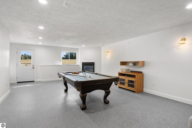 playroom with pool table and a textured ceiling