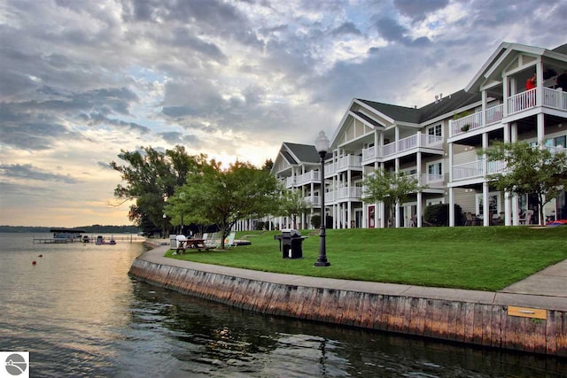 view of community featuring a yard and a water view