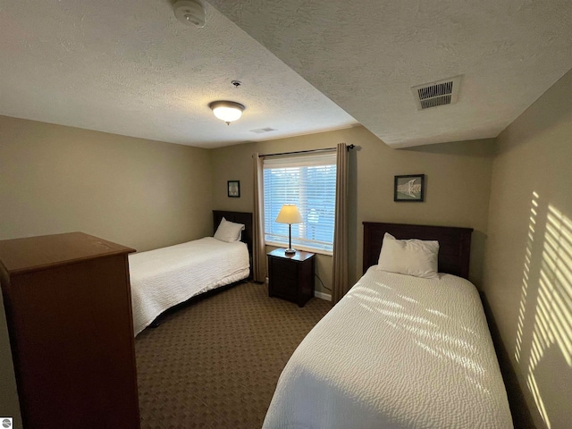 carpeted bedroom with a textured ceiling