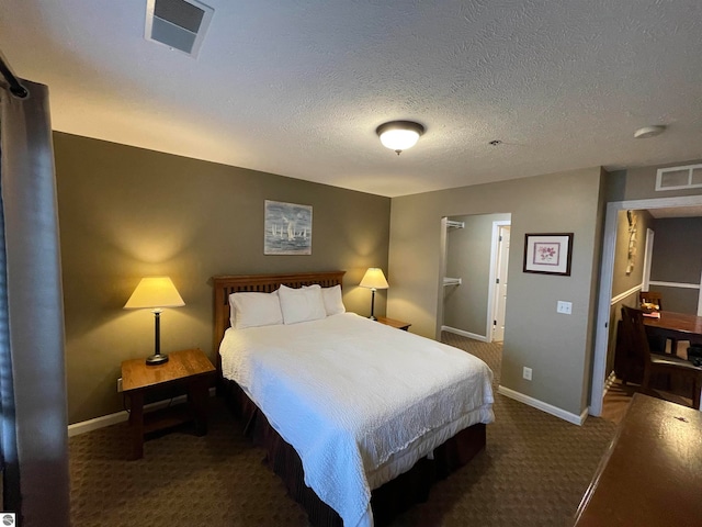 carpeted bedroom with a textured ceiling