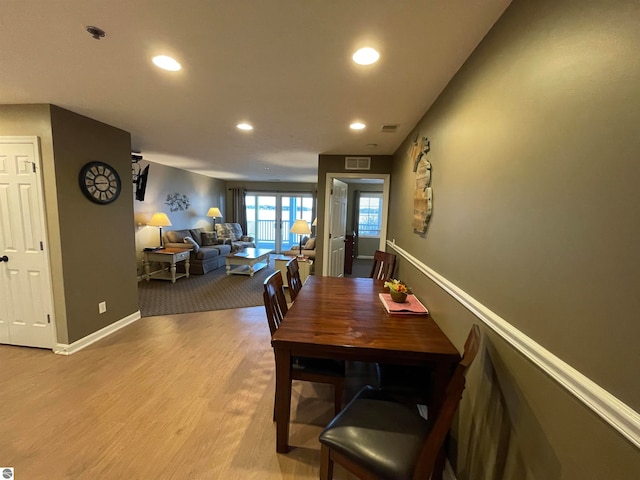 dining space with light hardwood / wood-style floors