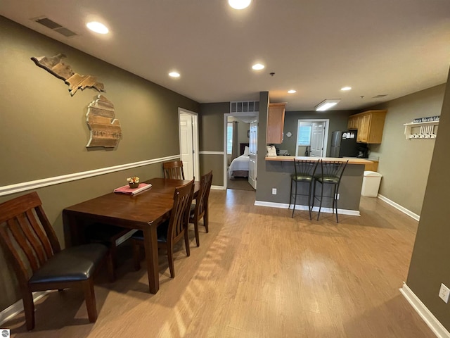 dining space with light wood-type flooring