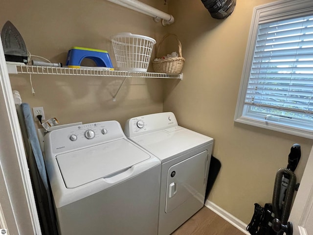 washroom featuring washing machine and dryer and wood-type flooring