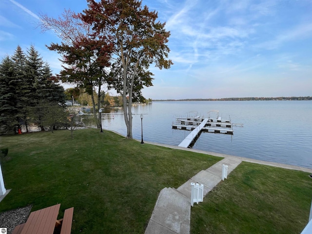 dock area featuring a water view and a yard