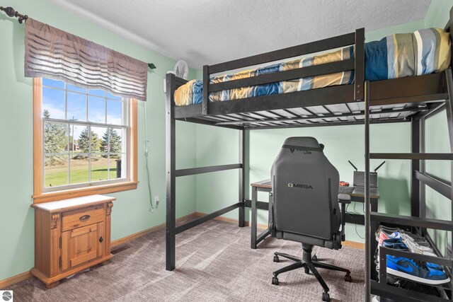 carpeted bedroom featuring a textured ceiling