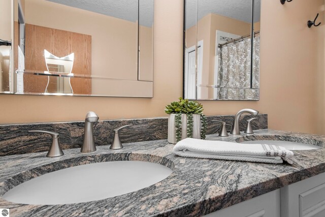 bathroom with vanity and a textured ceiling