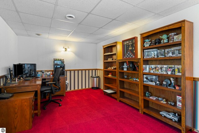 home office with a drop ceiling and carpet