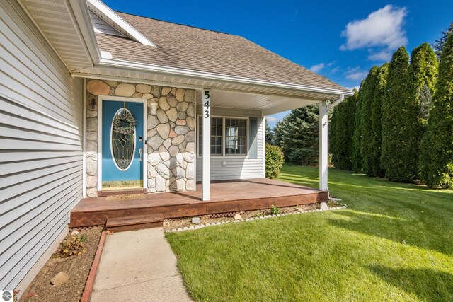 doorway to property with a yard