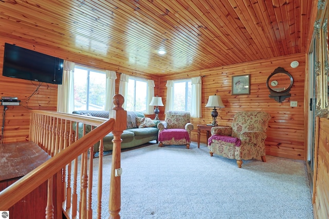 living room featuring wooden walls, wood ceiling, and carpet flooring