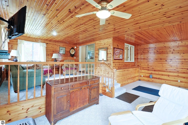 kitchen with wood walls, ceiling fan, wood ceiling, and light carpet