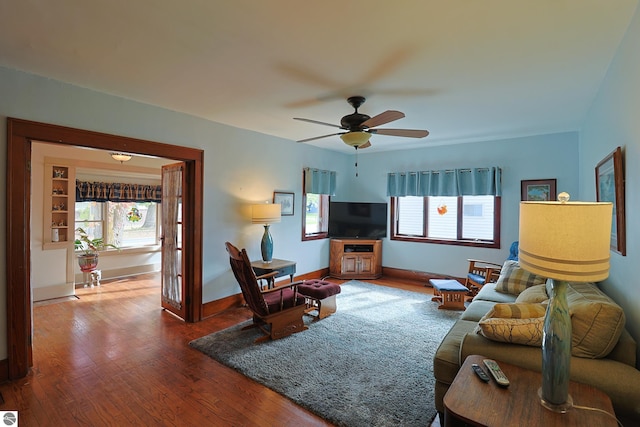 living room with ceiling fan and hardwood / wood-style floors