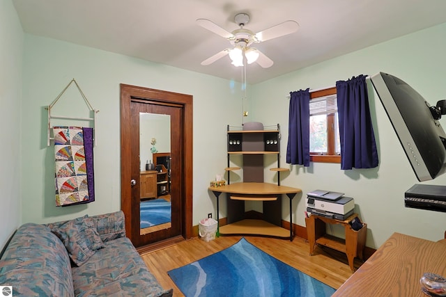 office area with light hardwood / wood-style flooring and ceiling fan