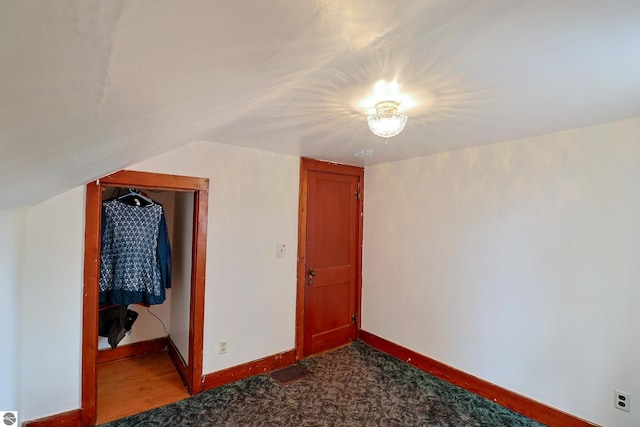 additional living space featuring lofted ceiling