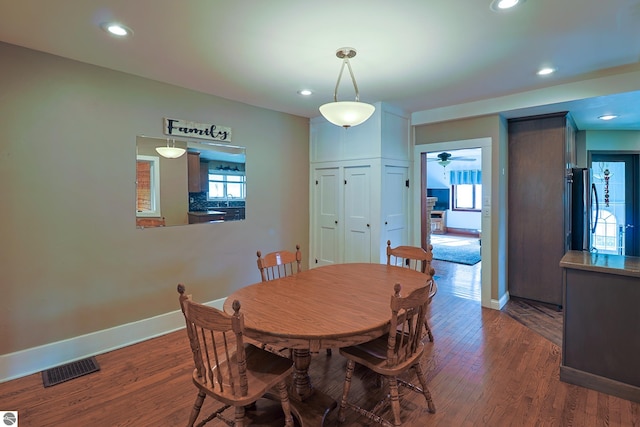 dining room featuring plenty of natural light, dark hardwood / wood-style floors, and ceiling fan