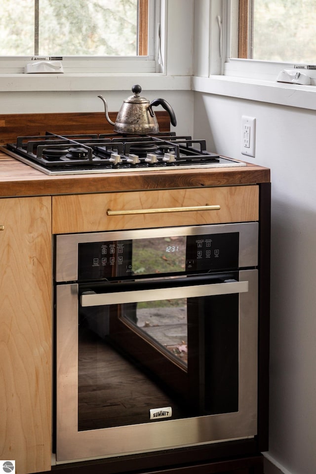 interior details featuring butcher block counters and oven