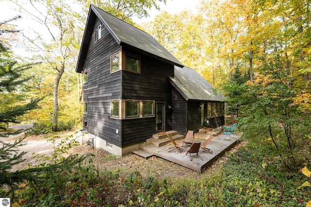 back of property with a wooden deck