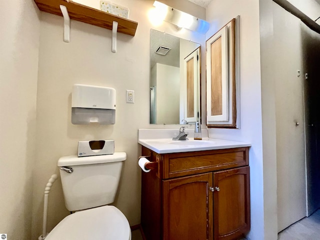 bathroom featuring vanity and toilet