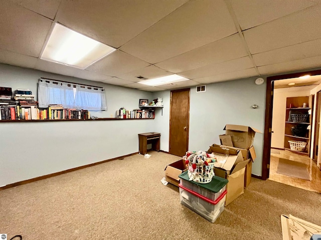 sitting room with a paneled ceiling and carpet