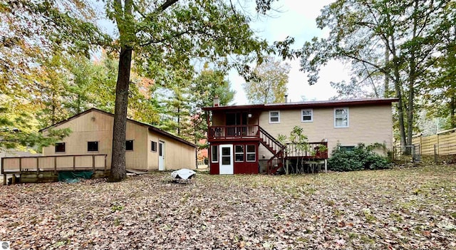 back of property featuring a wooden deck