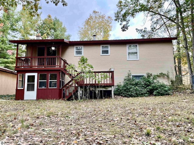 rear view of house with a wooden deck