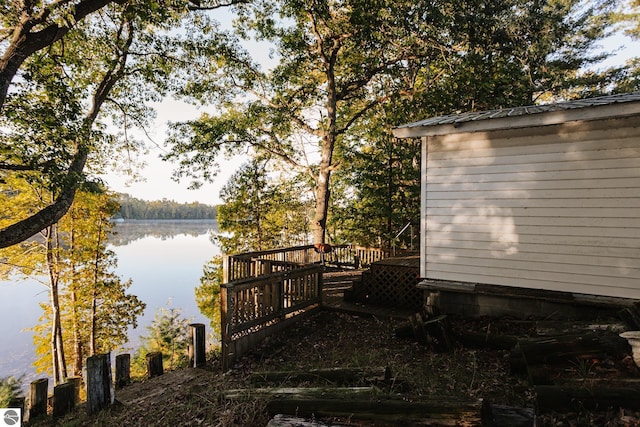 exterior space featuring a deck with water view