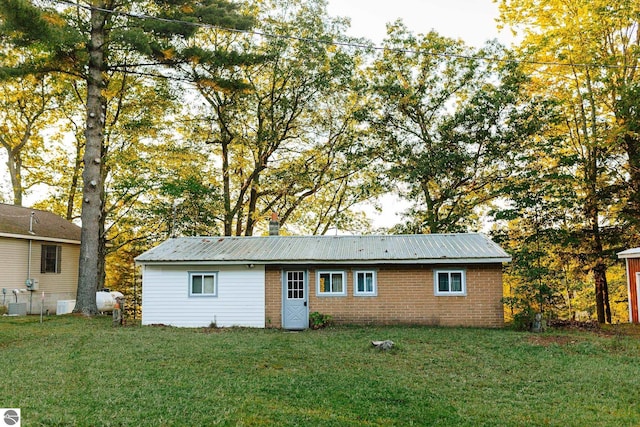 back of house with a lawn