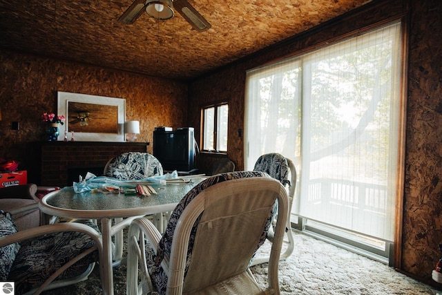 dining space featuring carpet and ceiling fan