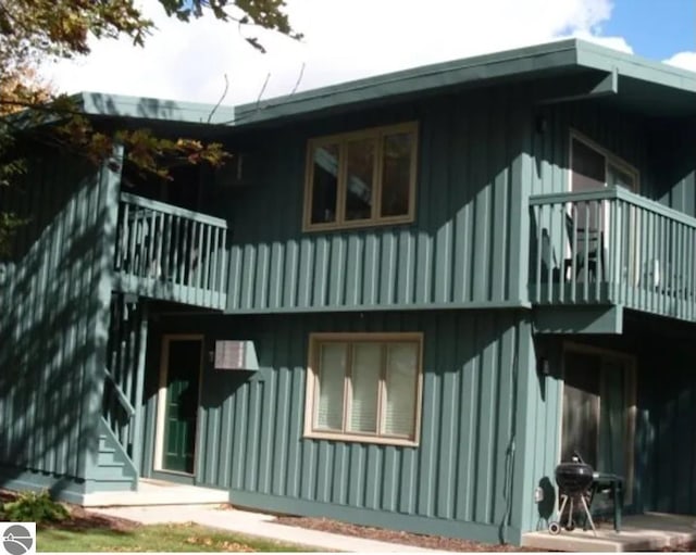 back of house featuring a balcony