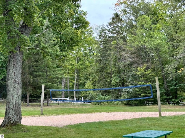 surrounding community featuring a yard and volleyball court