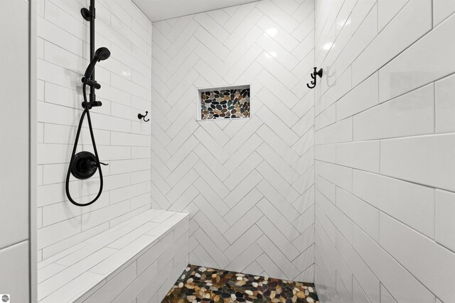 bathroom with a tile shower