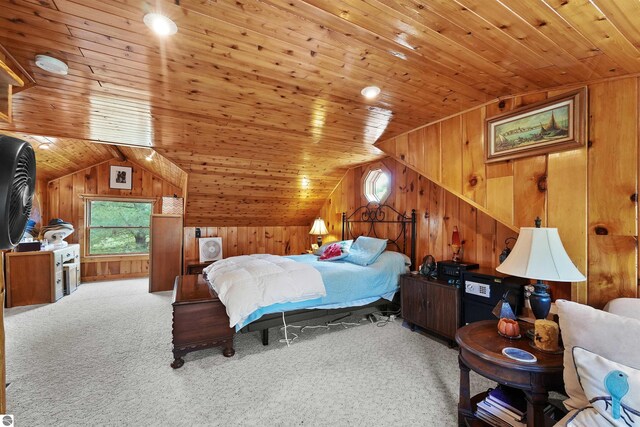 carpeted bedroom with wooden walls, wood ceiling, and lofted ceiling