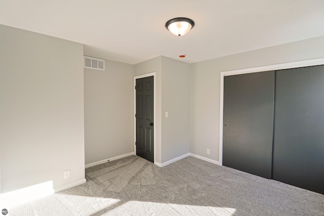 unfurnished bedroom featuring a closet and carpet flooring