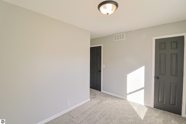 empty room featuring light carpet