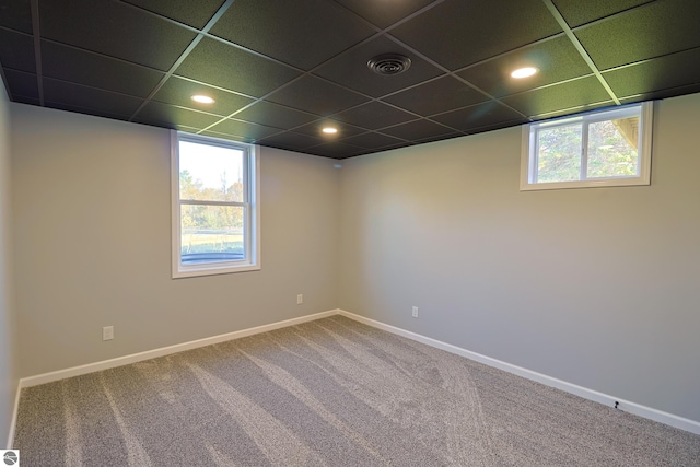 unfurnished room with a paneled ceiling and carpet