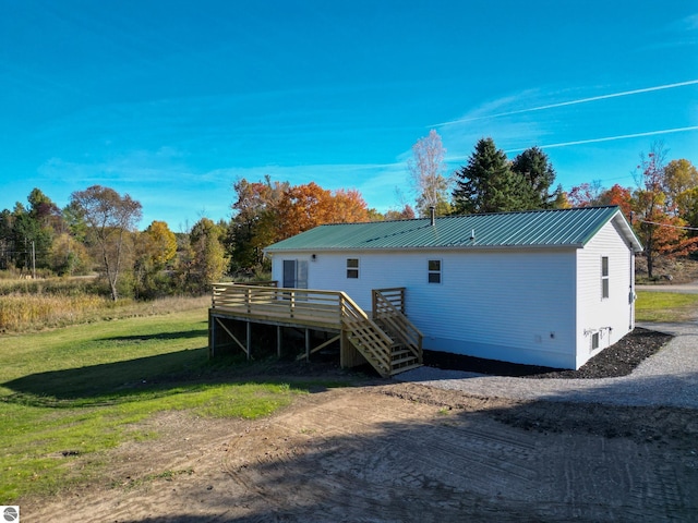 back of house with a yard and a wooden deck