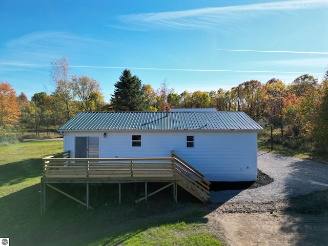 back of house with a yard and a wooden deck