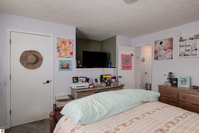 carpeted bedroom featuring a textured ceiling