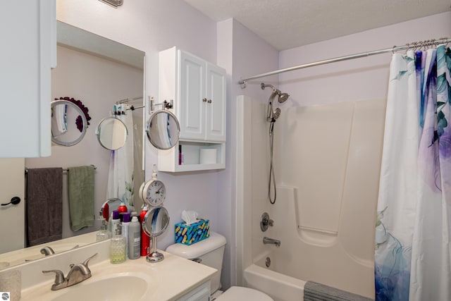 full bathroom with vanity, toilet, a textured ceiling, and shower / bath combo