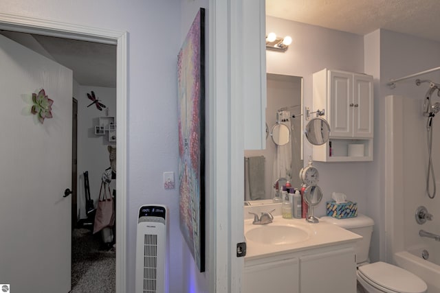 full bathroom featuring vanity, shower / washtub combination, toilet, and a textured ceiling