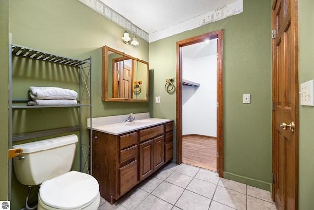 bathroom featuring vanity, toilet, and tile patterned flooring