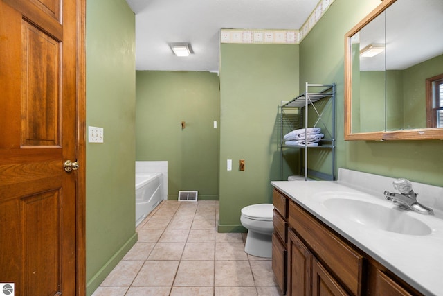 bathroom with vanity, toilet, a tub to relax in, and tile patterned flooring