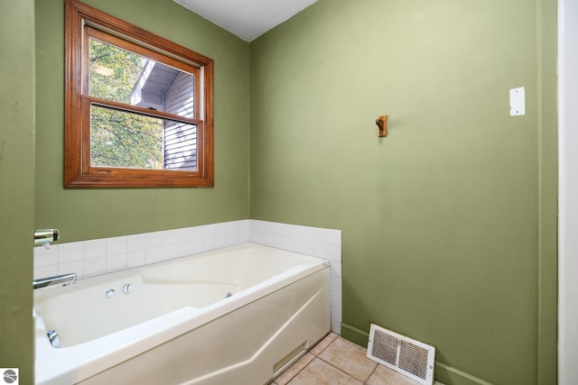 bathroom with tile patterned flooring and a washtub