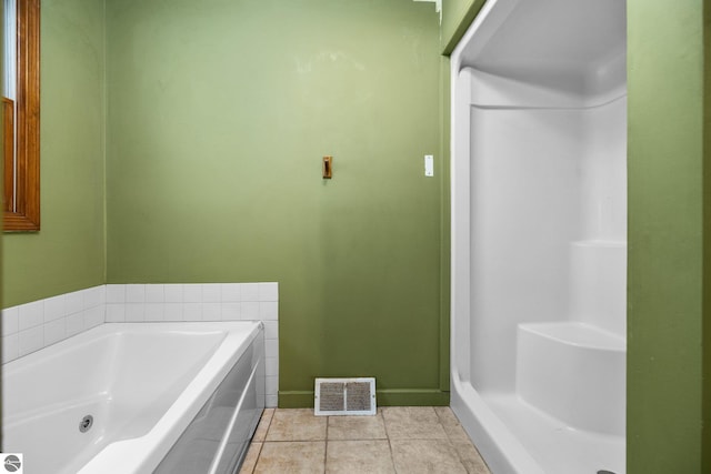 bathroom featuring tile patterned floors and a bathing tub