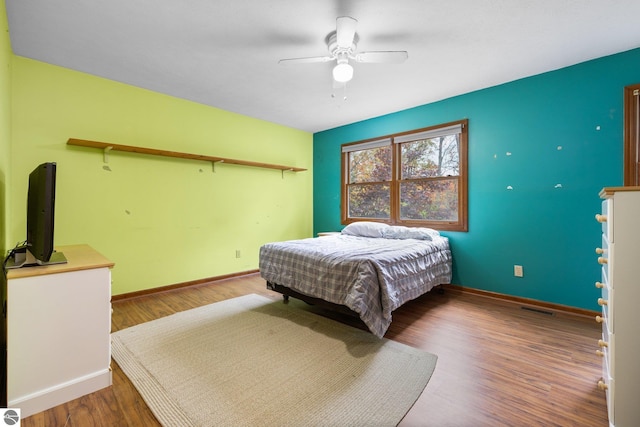 bedroom featuring ceiling fan and dark hardwood / wood-style flooring