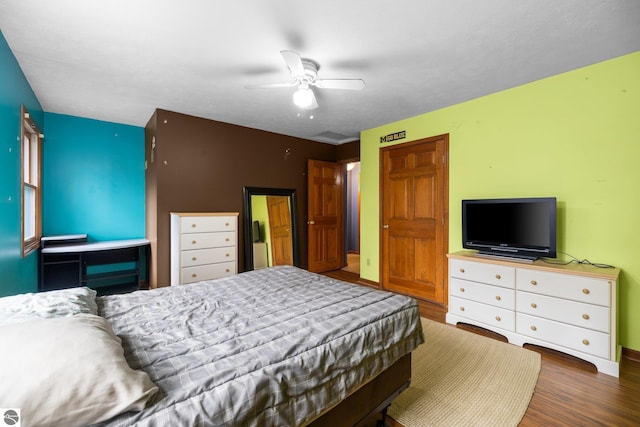 bedroom featuring dark wood-type flooring and ceiling fan