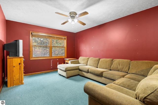 carpeted living room with a textured ceiling and ceiling fan